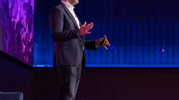 Jon Mew speaking on stage at IAB event